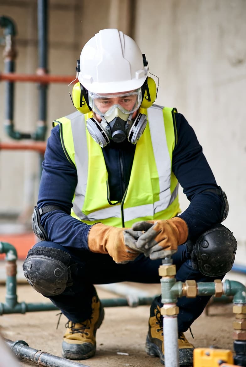 Plumber working on construction site